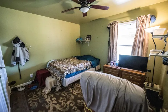 a bedroom with two beds and a window