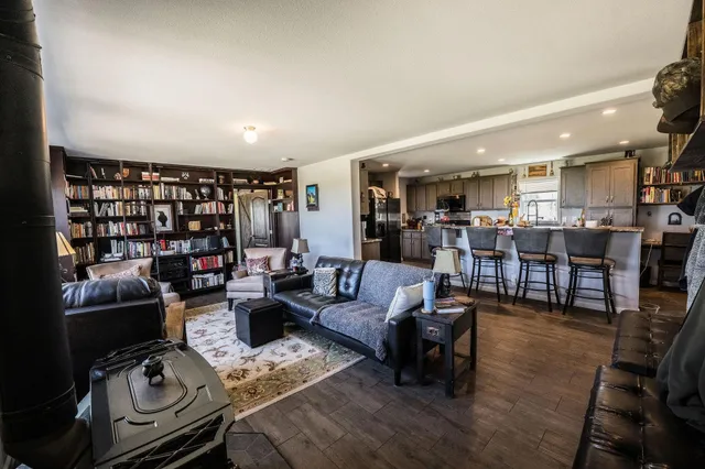 a living room with lots of furniture and wooden floor