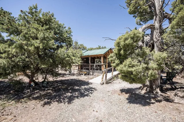 a view of a house with a tree in the background