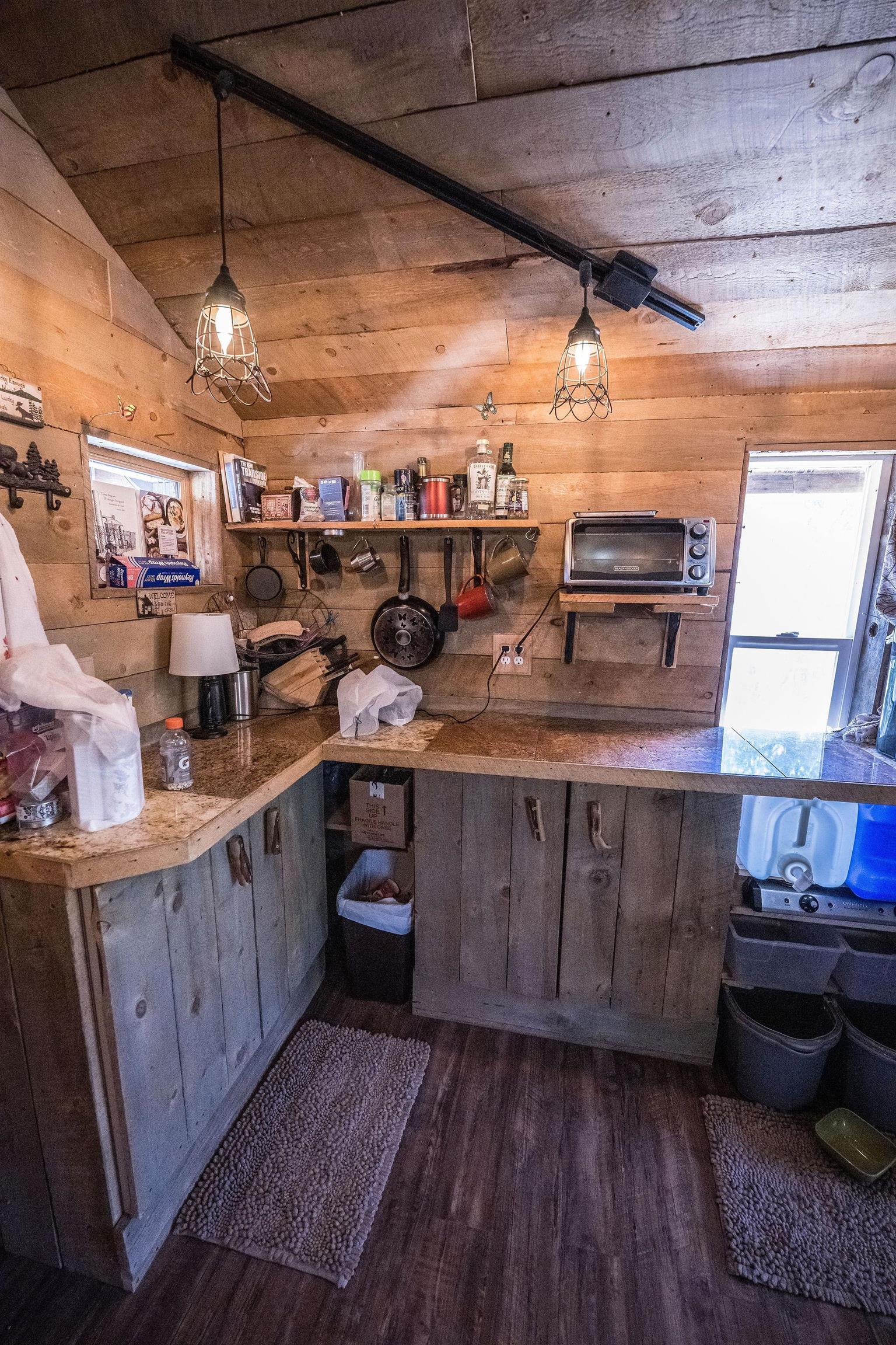19958 Miller Canyon Ranch Road Glade Park, CO 81523 - Photo 31 of 42 a kitchen with a wooden floor and cabinets