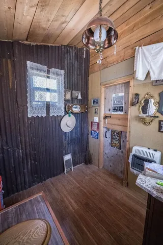 a bedroom with a bed mirror and a window