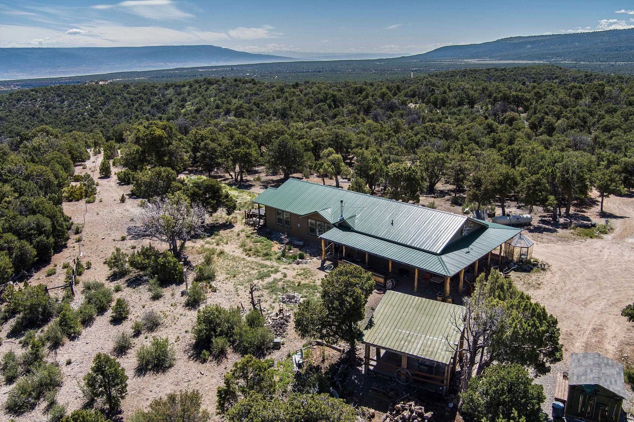 19958 Miller Canyon Ranch Road Glade Park, CO 81523 - Photo 36 of 42 an aerial view of a house with a yard