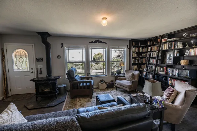 a living room with furniture and a large window
