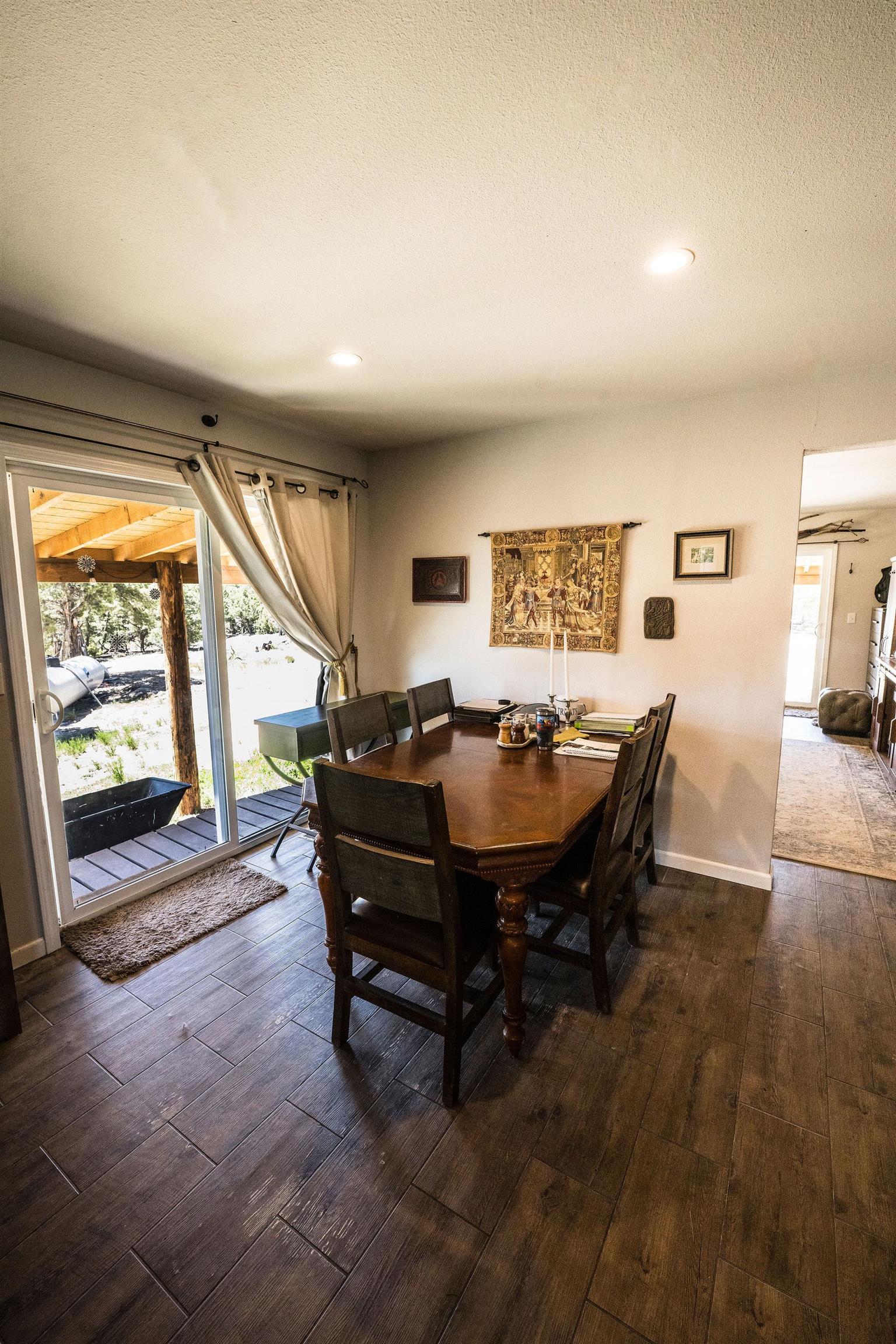 19958 Miller Canyon Ranch Road Glade Park, CO 81523 - Photo 8 of 42 a living room with furniture a large window and a fireplace