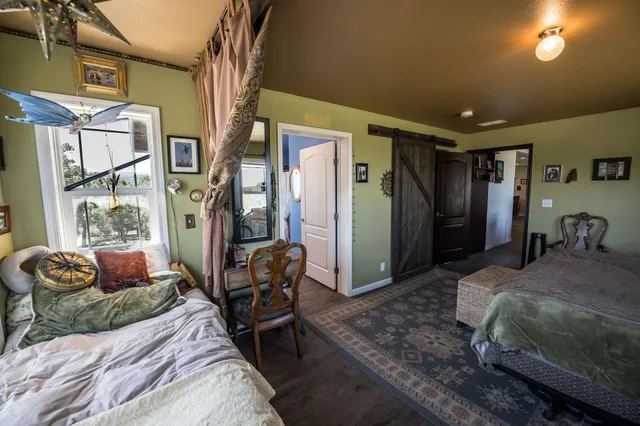 a spacious bedroom with a bed couch and a window