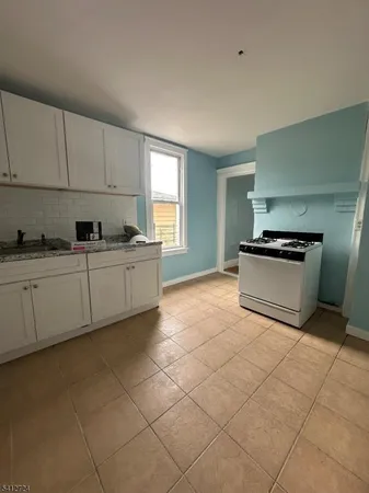 a kitchen with granite countertop a sink and cabinets