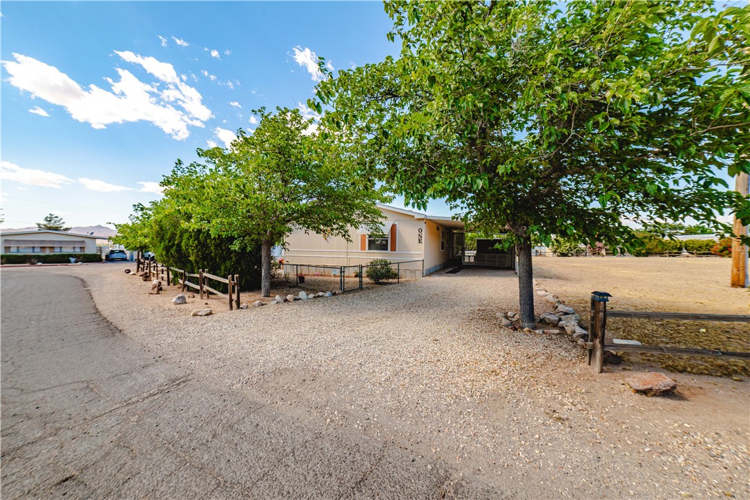 3003 Hualapai Mountain Road Kingman, AZ 86401 - Photo 45 of 49 a white house that has a tree in front of it