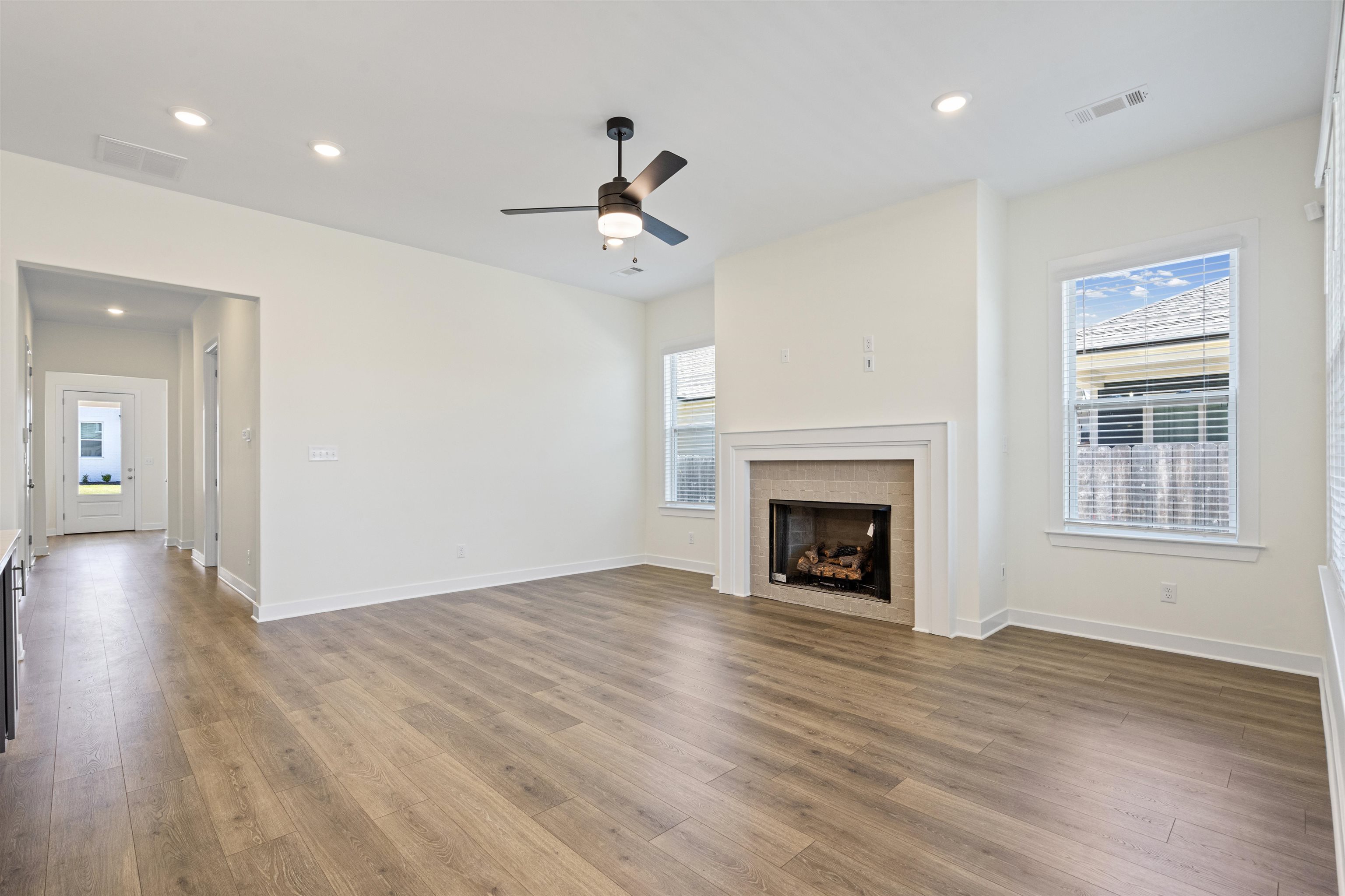 5666 Pleasant Pk Place Arlington, TN 38002 - Photo 12 of 27 Spacious living area featuring wood-finish flooring, a tiled fireplace with a mantel, recessed lighting, and a ceiling fan