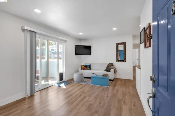 a living room with furniture window and wooden floor