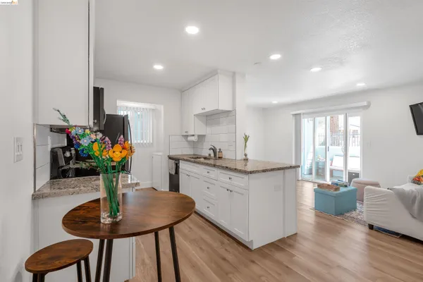 a kitchen with counter top space cabinets and dining table