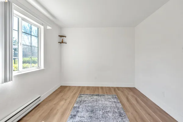 a view of a room with wooden floor and window