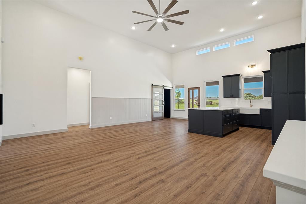 1150 Doss Road Millsap, TX 76066 - Photo 13 of 32 Open-concept living area with vaulted ceilings and wood-finish flooring
