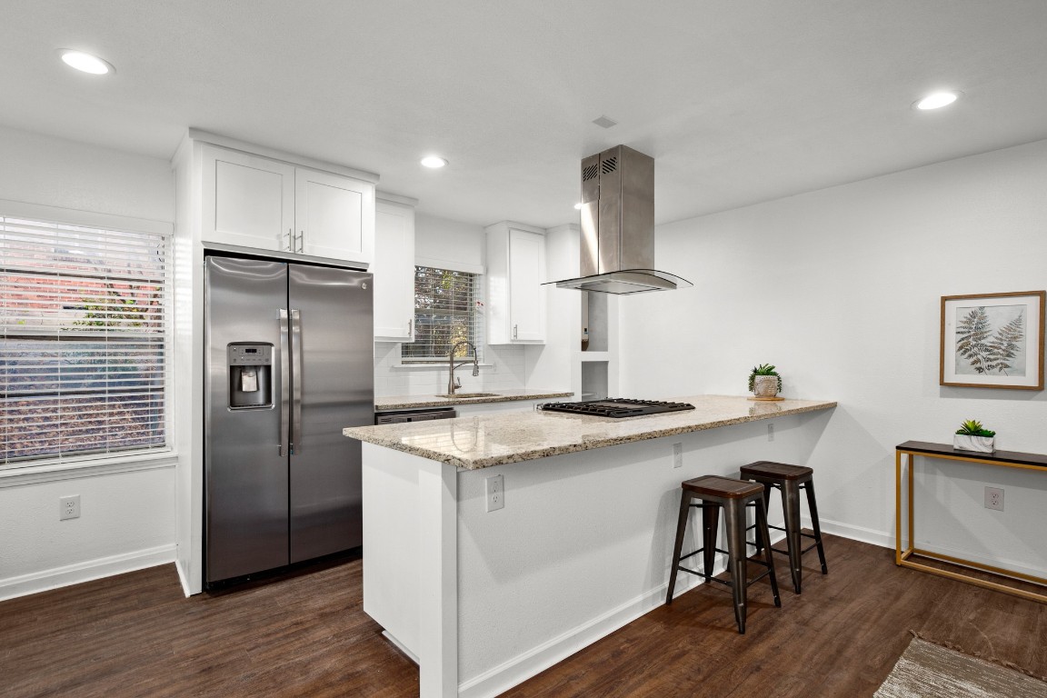 301 East 33rd Street, Unit 1 Austin, TX 78705 - Photo 2 of 9 a kitchen with stainless steel appliances granite countertop a sink a stove a refrigerator and island