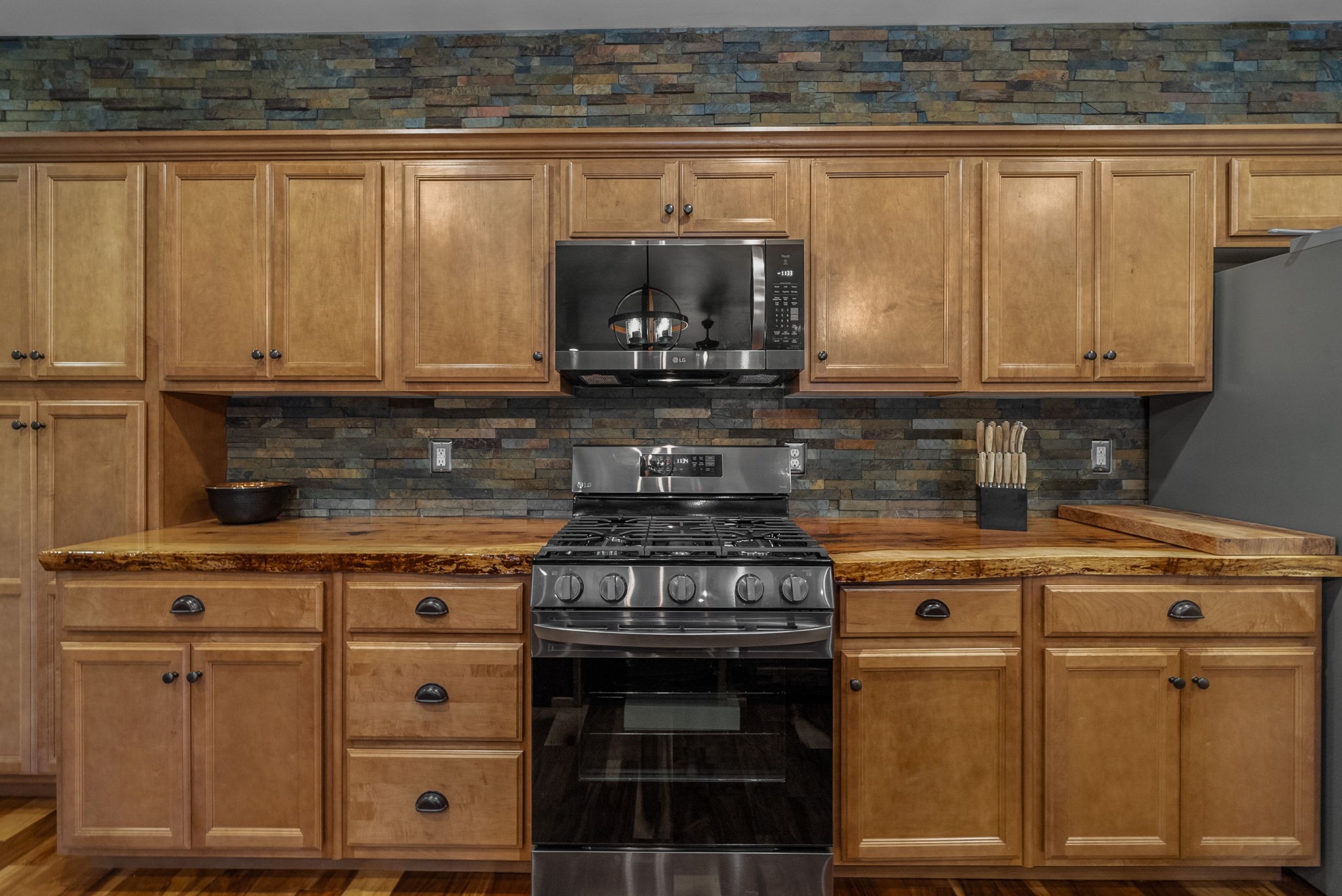 950 Choate Road Dickson, TN 37055 - Photo 9 of 56 a kitchen with granite countertop a stove top oven cabinetry and granite counter top