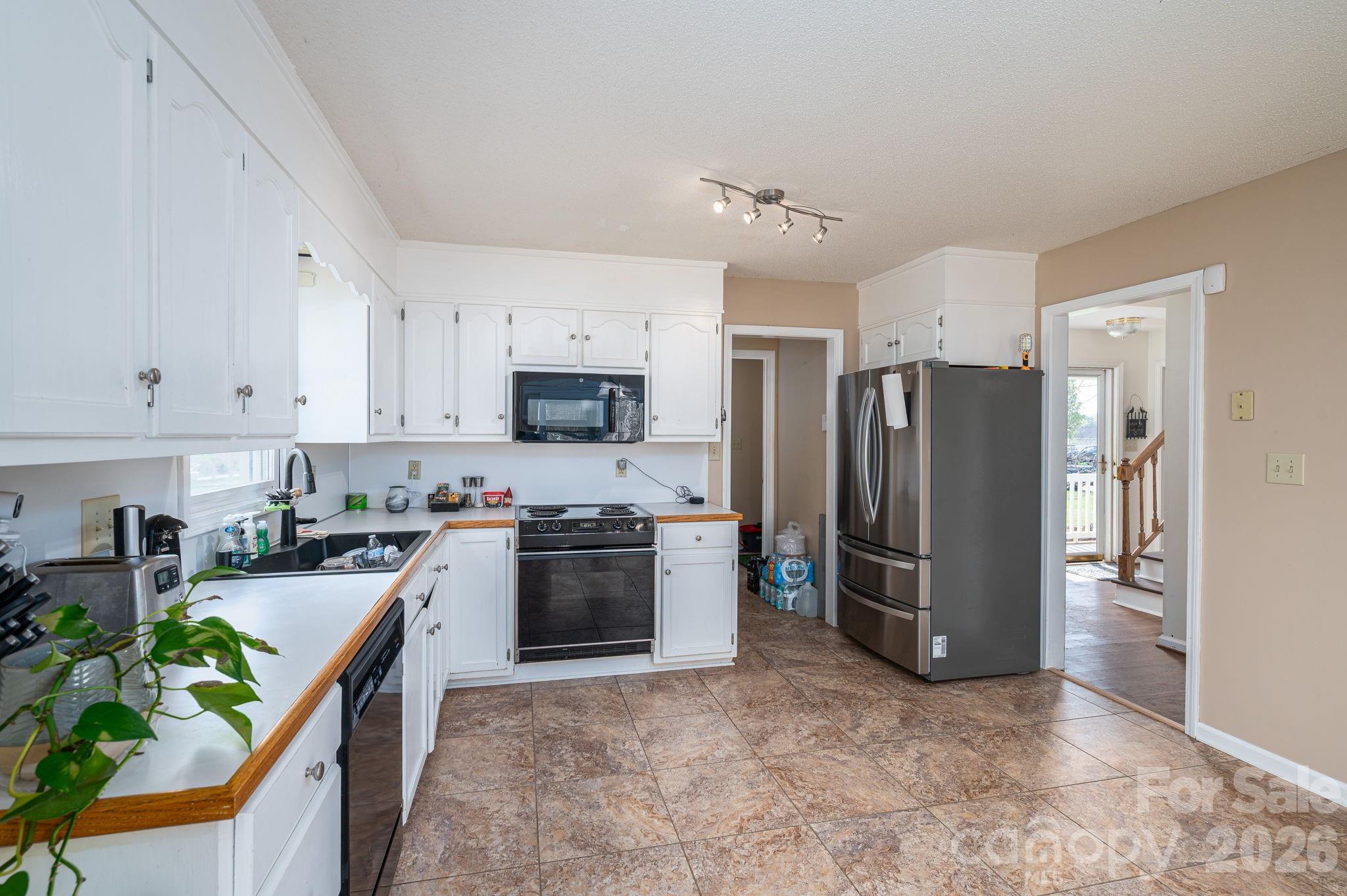4503 Briar Creek Road Maiden, NC 28650 - Photo 13 of 48 a kitchen with stainless steel appliances granite countertop a refrigerator stove and sink