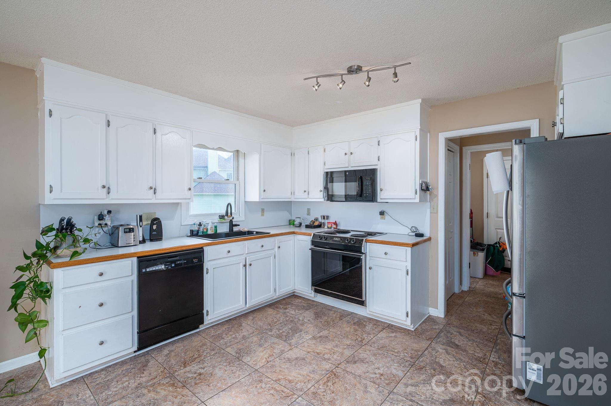 4503 Briar Creek Road Maiden, NC 28650 - Photo 14 of 48 a kitchen with cabinets stainless steel appliances and wooden floor
