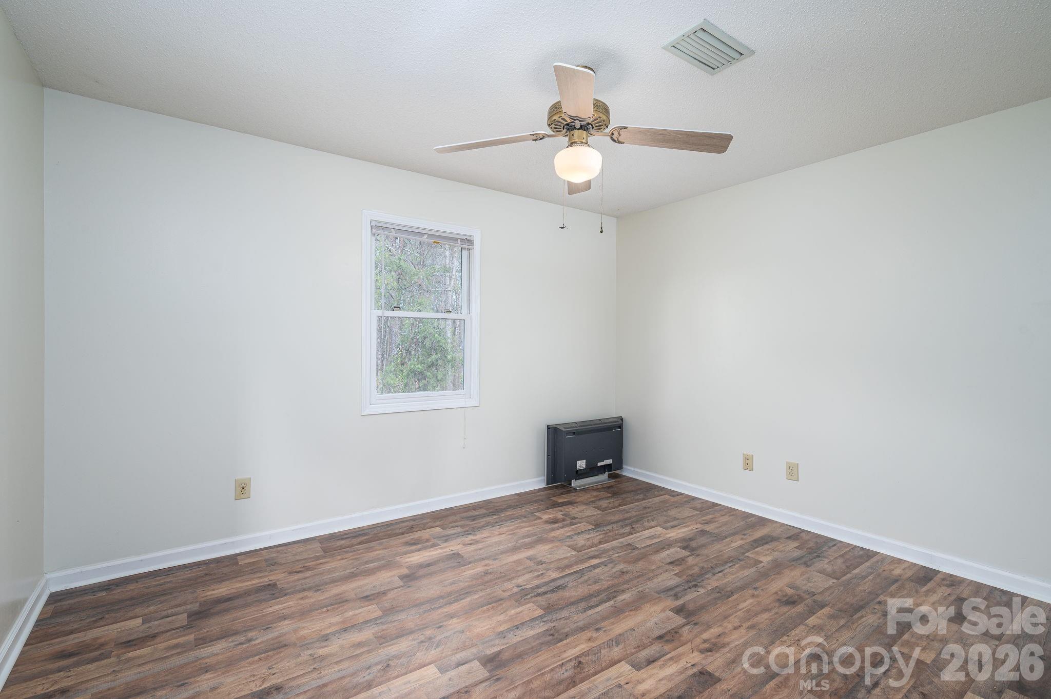4503 Briar Creek Road Maiden, NC 28650 - Photo 17 of 48 an empty room with a window and wooden floor