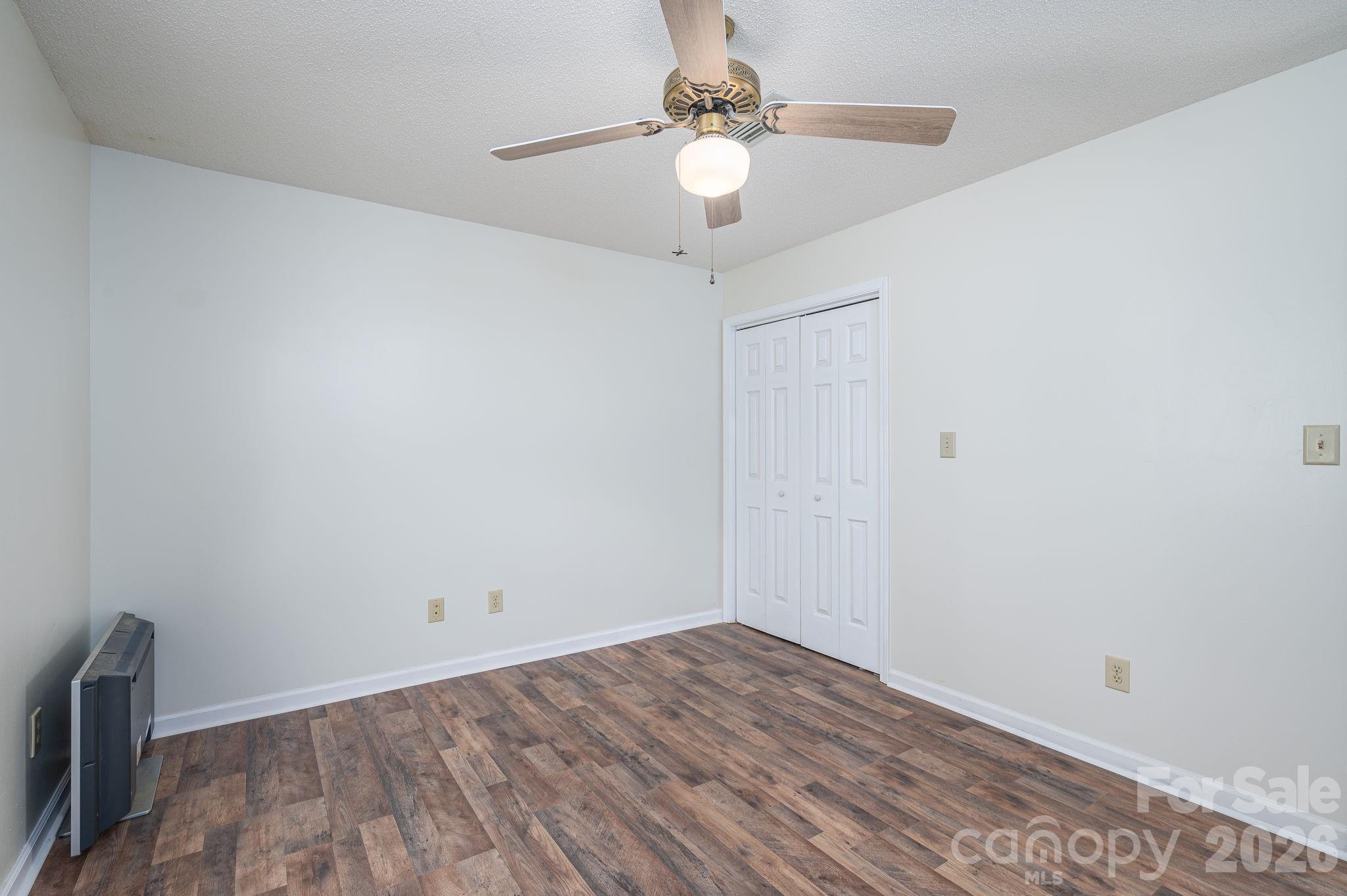 4503 Briar Creek Road Maiden, NC 28650 - Photo 18 of 48 a view of a room with wooden floor and a ceiling fan