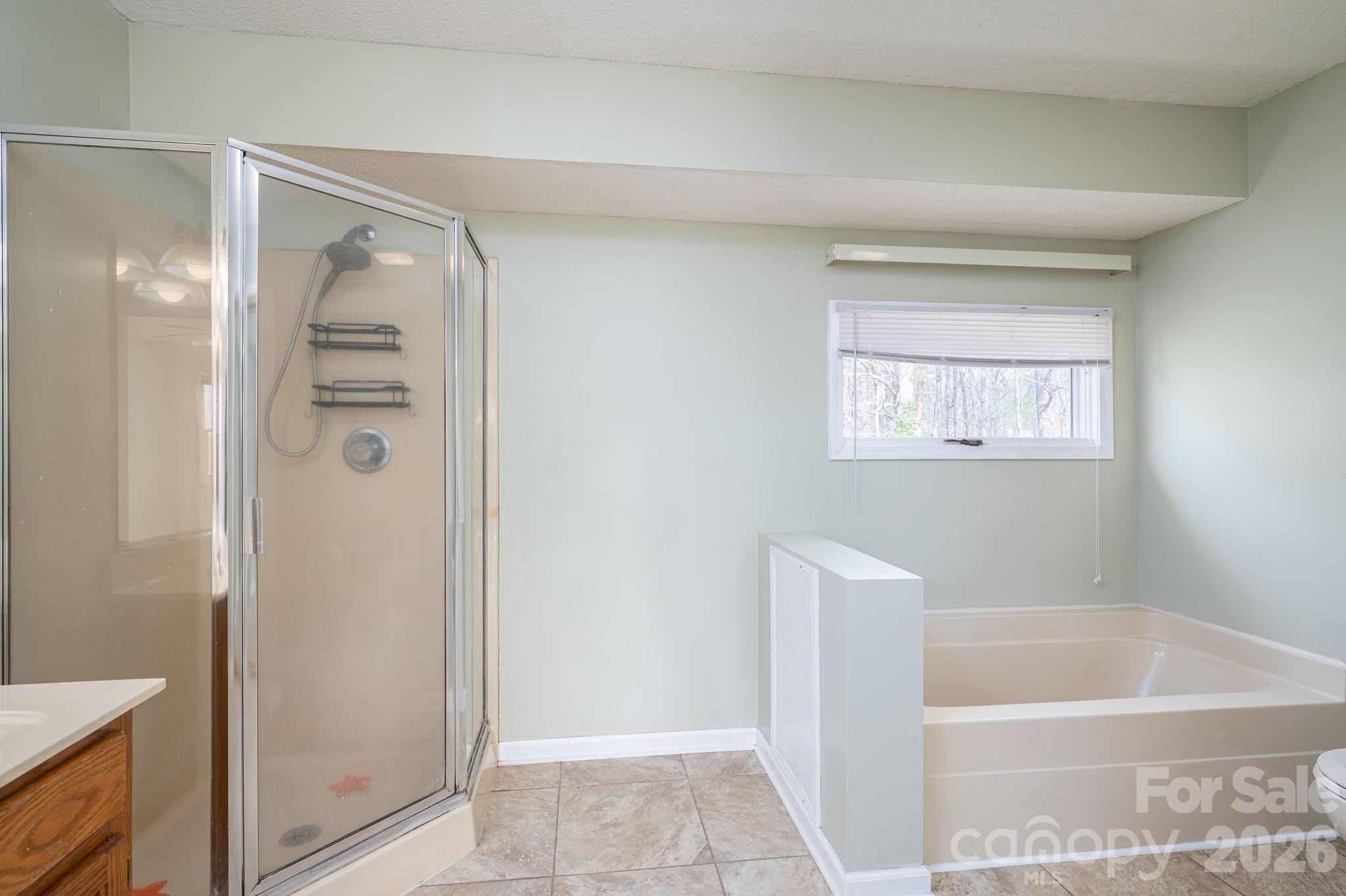 4503 Briar Creek Road Maiden, NC 28650 - Photo 26 of 48 a bathroom with a shower a bathtub and a shower