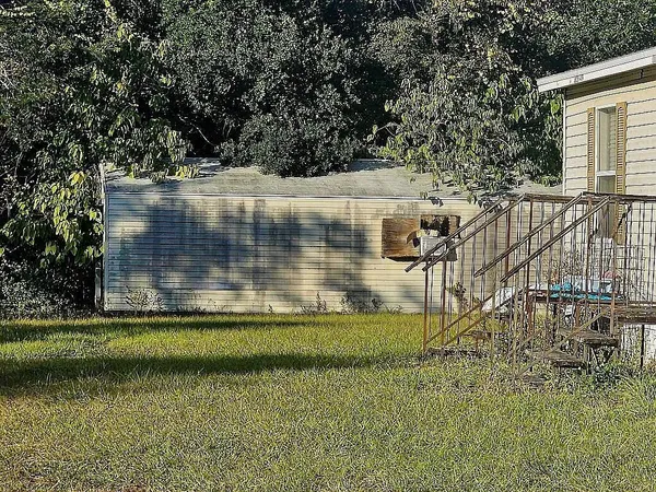 a view of a balcony with a yard