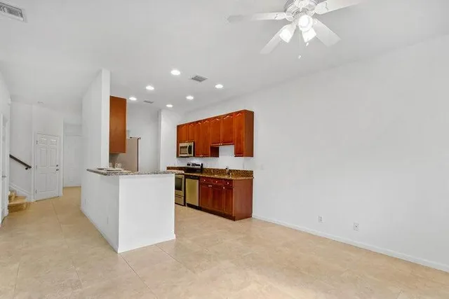 a kitchen with stainless steel appliances a white stove top oven and a refrigerator