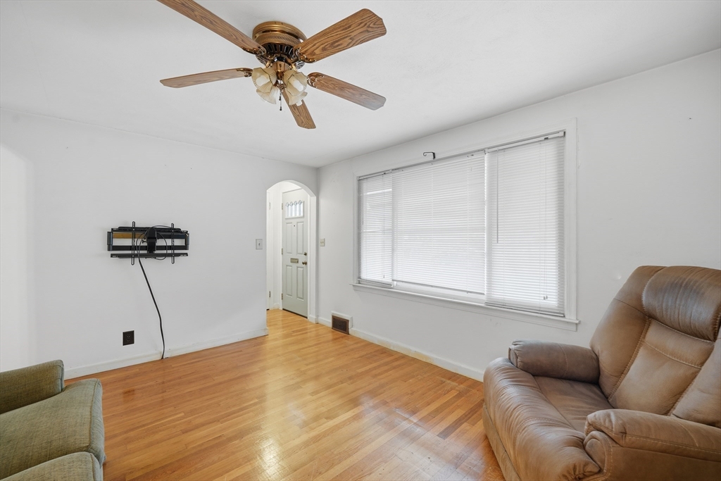 47 Holy Cross Street Springfield, MA 01104 - Photo 13 of 22 a bedroom with furniture a ceiling fan and a wooden floor