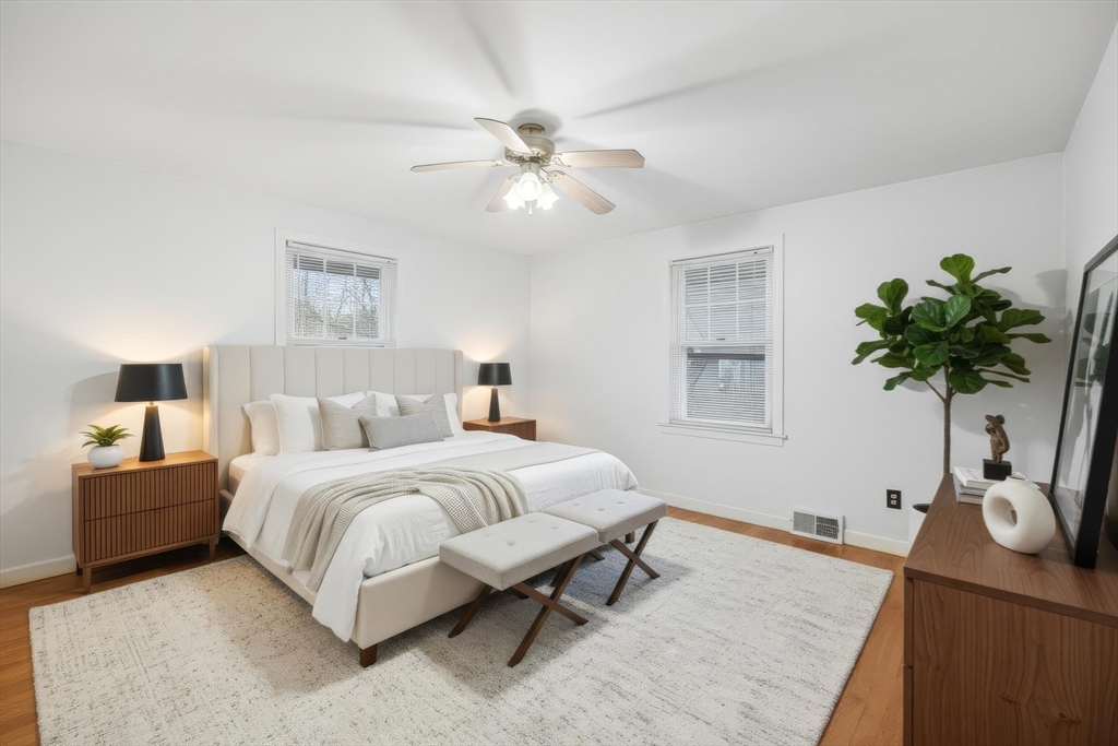 47 Holy Cross Street Springfield, MA 01104 - Photo 16 of 22 a bedroom with a bed and a potted plant