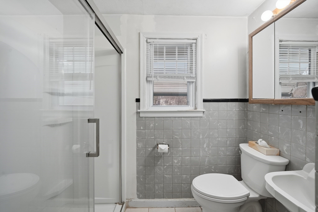 47 Holy Cross Street Springfield, MA 01104 - Photo 17 of 22 a white toilet sitting next to a bathroom sink