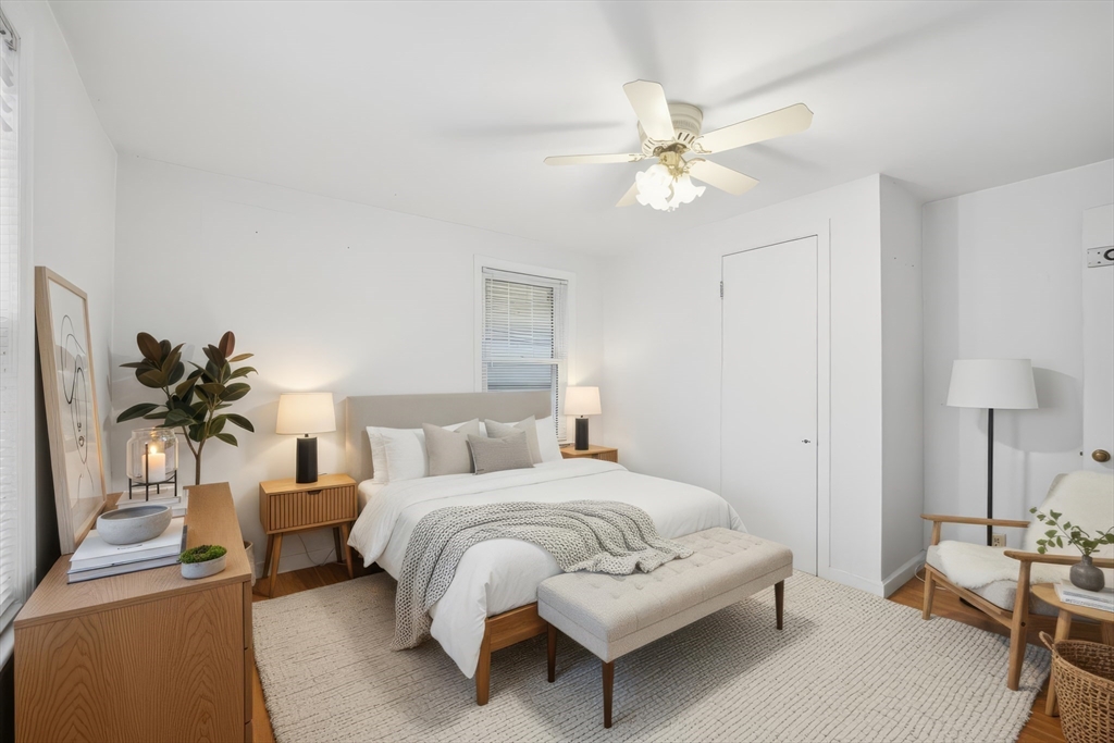 47 Holy Cross Street Springfield, MA 01104 - Photo 20 of 22 a bedroom with a bed and a chandelier