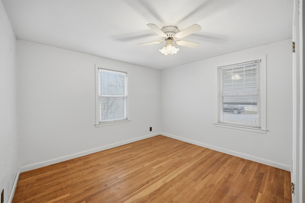 47 Holy Cross Street Springfield, MA 01104 - Photo 21 of 22 a view of an empty room with wooden floor and a window