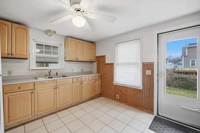 a kitchen with sink cabinets and window