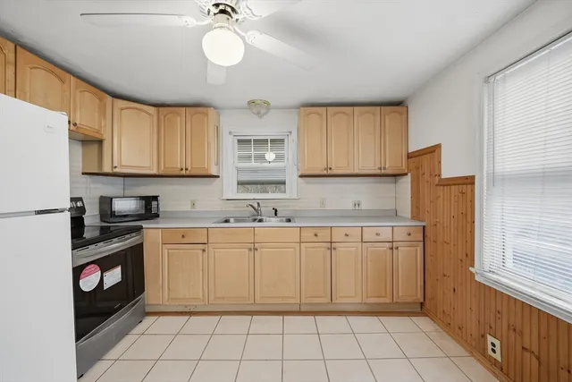 a kitchen with stainless steel appliances granite countertop a sink and cabinets