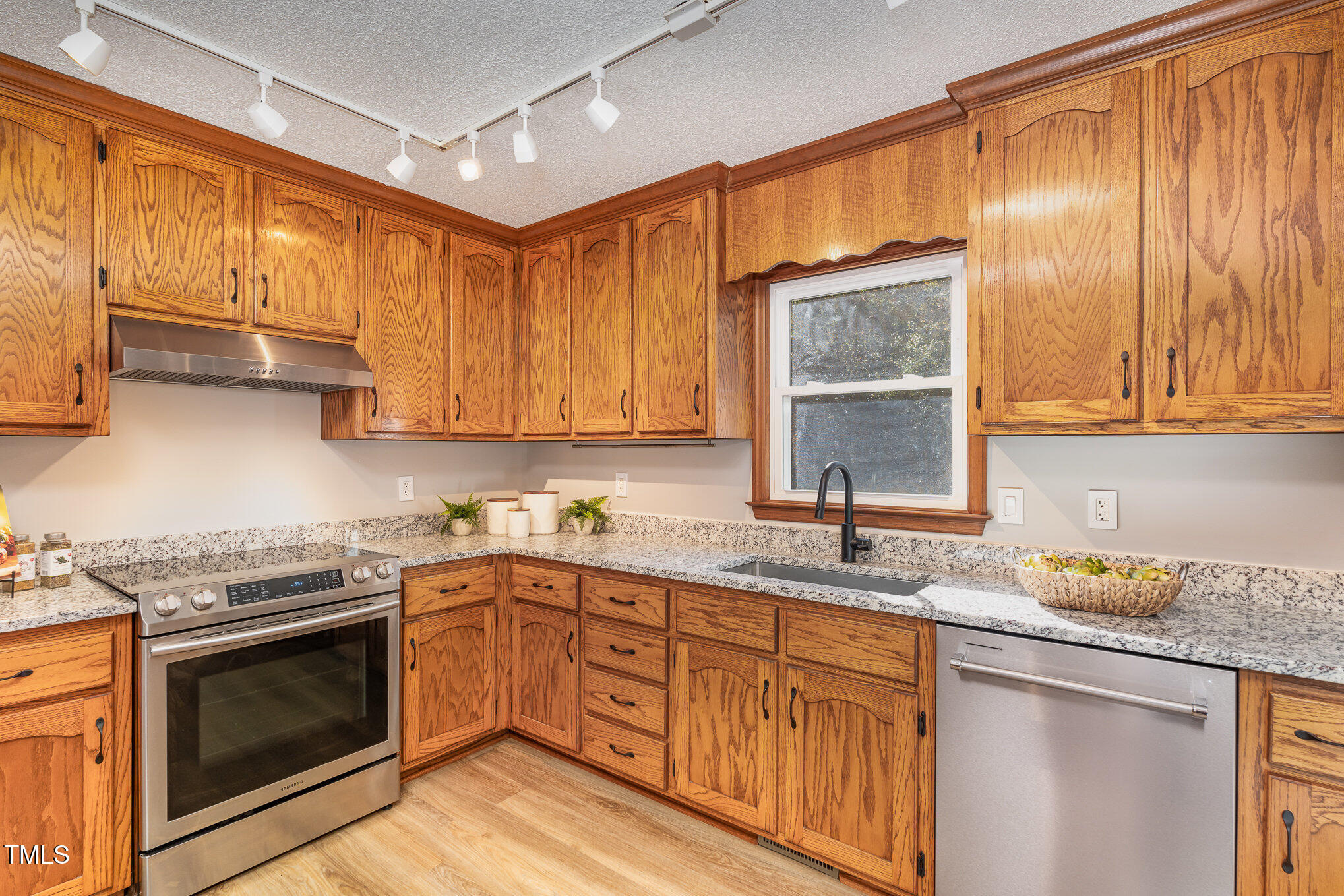 5820 Hampton Ridge Road Raleigh, NC 27603 - Photo 5 of 12 a kitchen with granite countertop cabinets stainless steel appliances a sink and window
