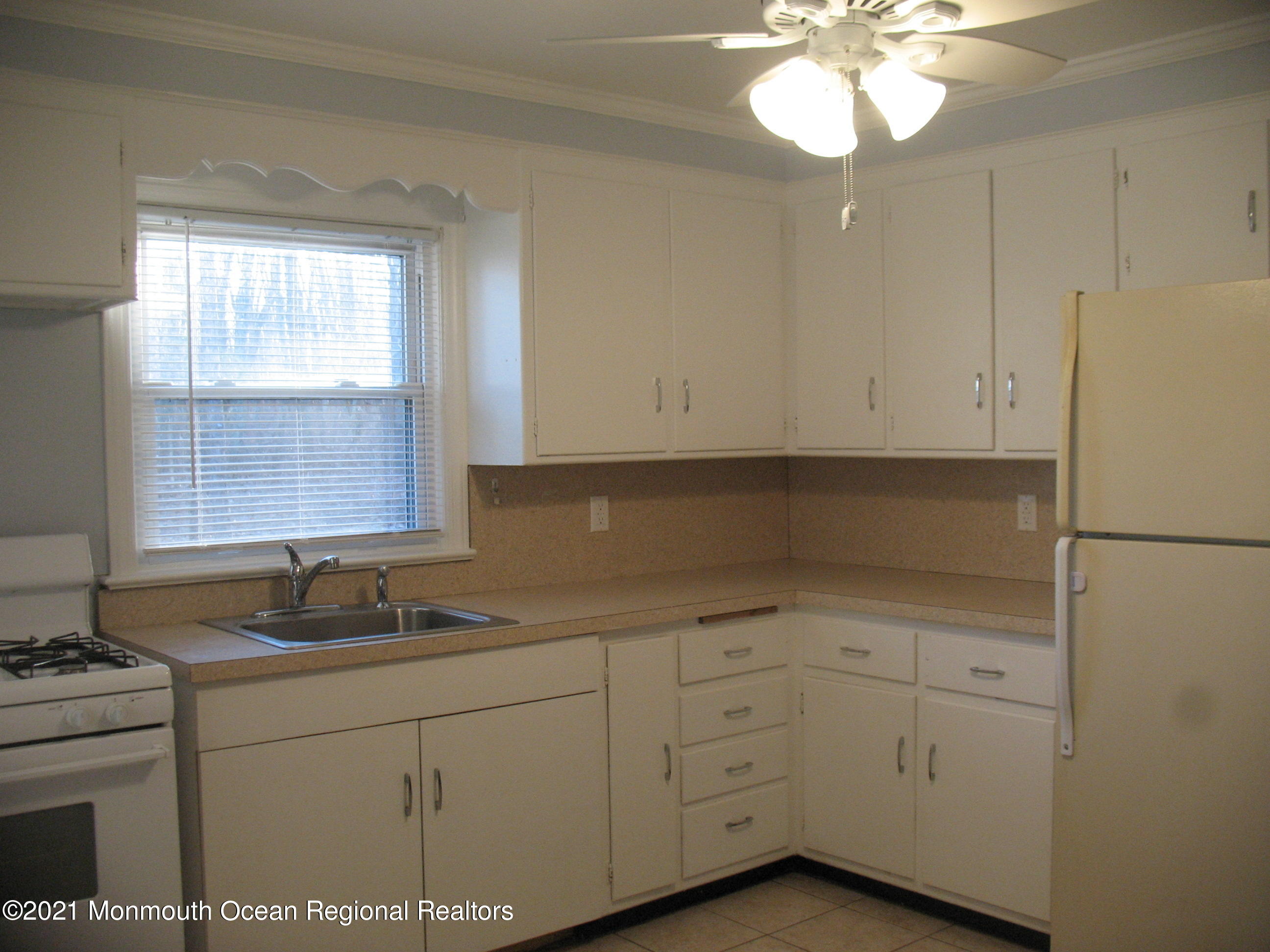 222 Windeler Road Howell, NJ 07731 - Photo 5 of 17 a kitchen with cabinets appliances a sink and a window
