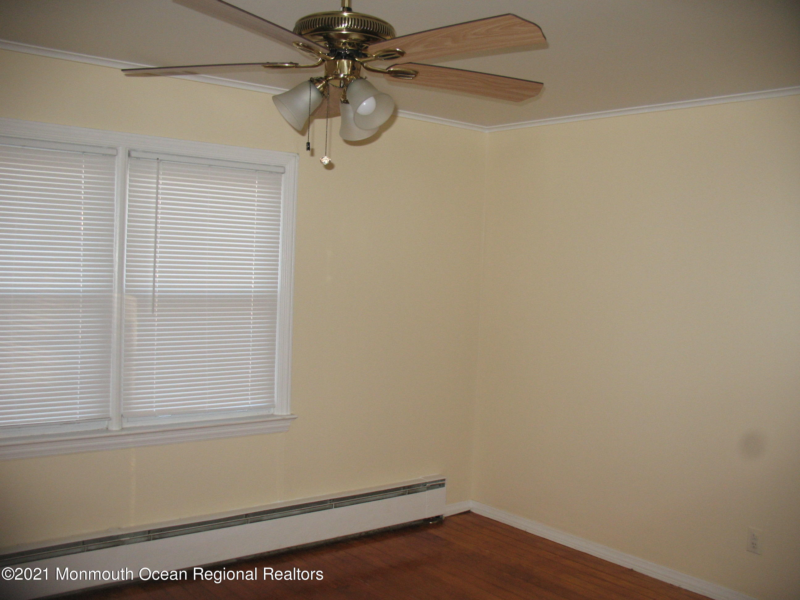 222 Windeler Road Howell, NJ 07731 - Photo 9 of 17 a view of a small space with wooden floor and fan