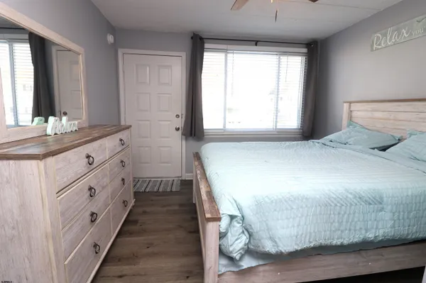 a spacious bedroom with a bed and a window