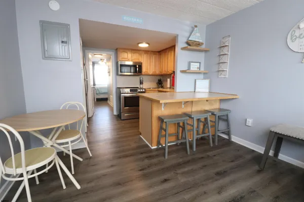 a view of a dining room with furniture and wooden floor