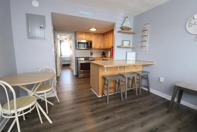 a view of a dining room with furniture and wooden floor