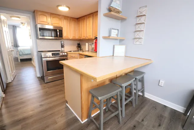 a kitchen with stainless steel appliances a stove a sink dishwasher and a refrigerator