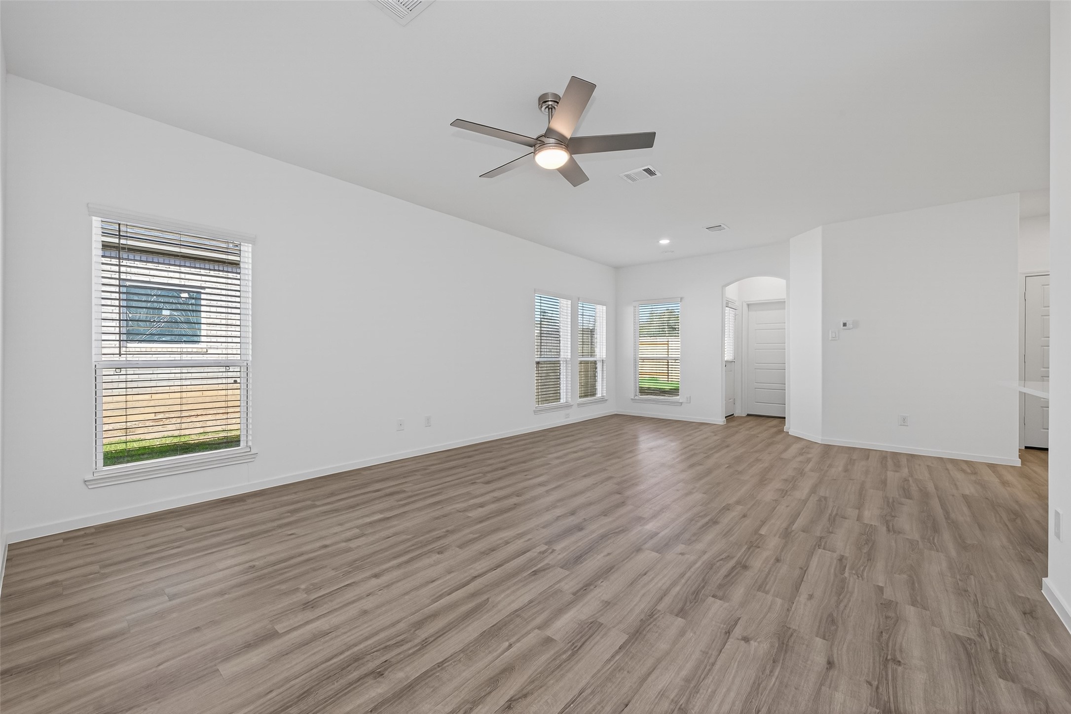 9718 Enclave Ridge Road Willis, TX 77318 - Photo 11 of 34 a view of an empty room with wooden floor and a window
