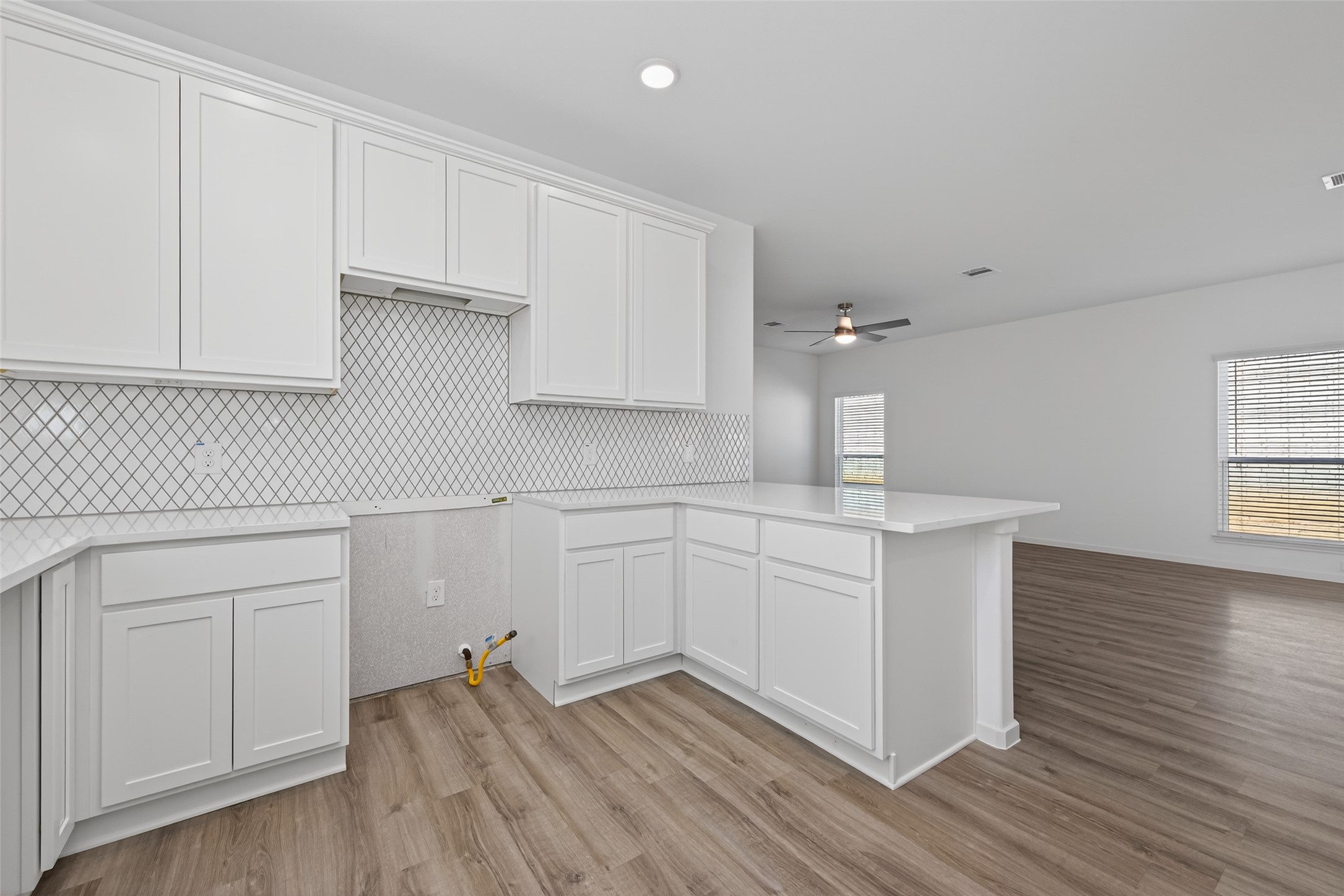 9718 Enclave Ridge Road Willis, TX 77318 - Photo 12 of 34 a kitchen with white cabinets and sink