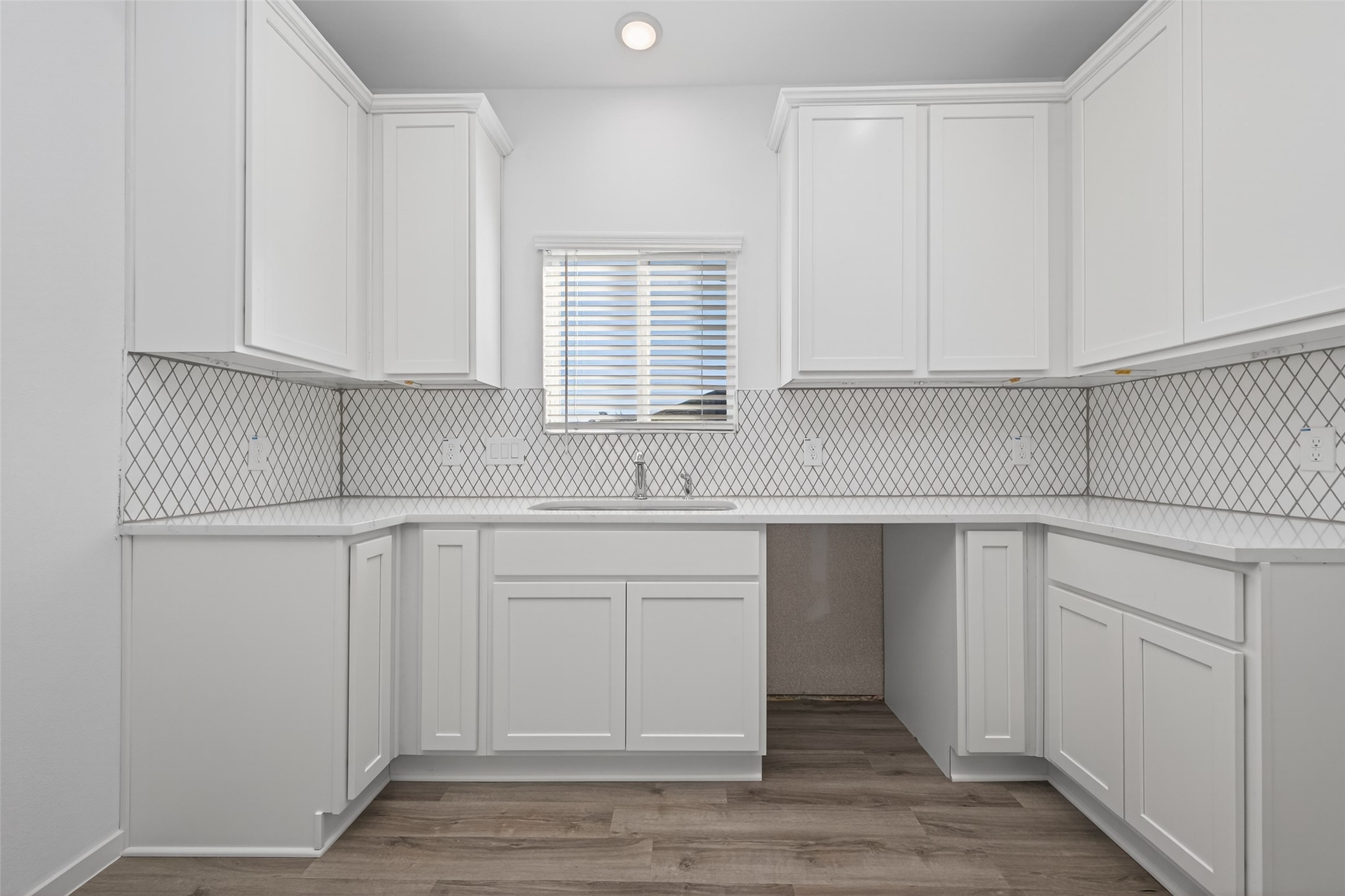 9718 Enclave Ridge Road Willis, TX 77318 - Photo 15 of 34 a kitchen with white cabinets and sink