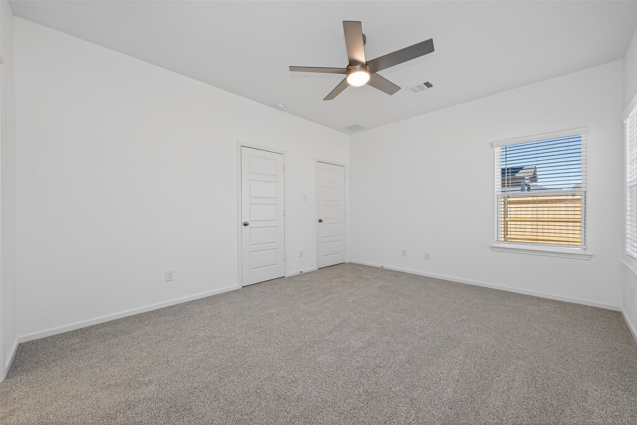 9718 Enclave Ridge Road Willis, TX 77318 - Photo 23 of 34 an empty room with a window and a fan