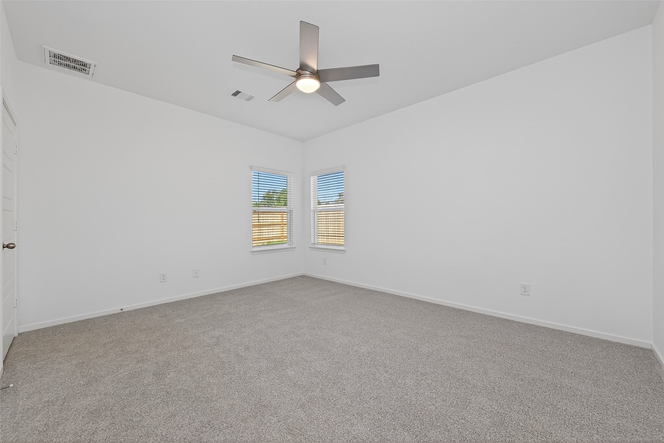 9718 Enclave Ridge Road Willis, TX 77318 - Photo 24 of 34 an empty room with a ceiling fan and a window