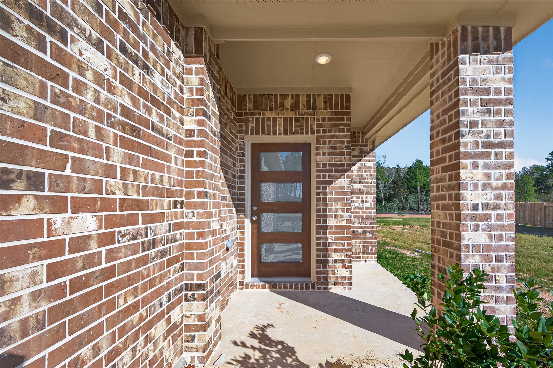9718 Enclave Ridge Road Willis, TX 77318 - Photo 5 of 34 a view of a brick house with a street