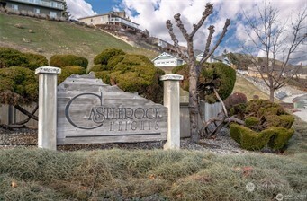 756 Castle Heights Drive Wenatchee, WA 98801 - Photo 2 of 22 a sign that is sitting on a rock