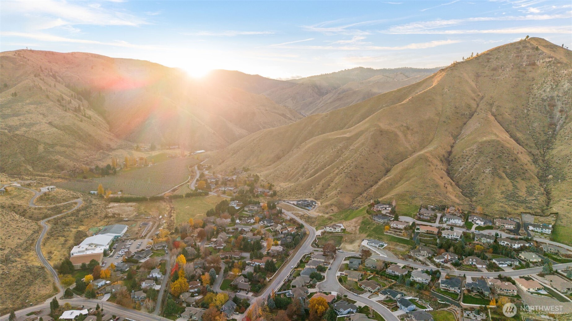 756 Castle Heights Drive Wenatchee, WA 98801 - Photo 8 of 22 a view of a dry yard with mountains in the background