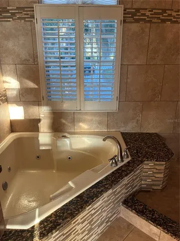 a bathroom with a bathtub and shower