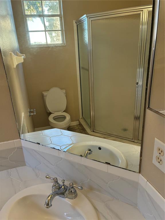 41515 Silver Drive Umatilla, FL 32784 - Photo 16 of 29 a bathroom with a sink a toilet and shower