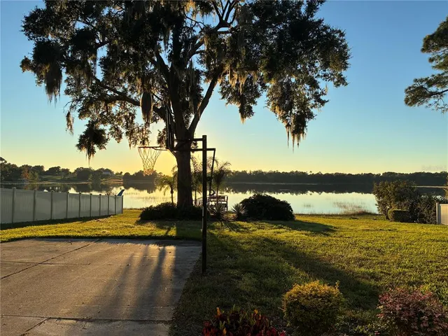 a view of a lake with houses in the background